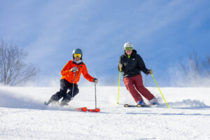 Skiers coming down Rib Mountain