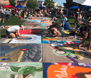 Artist working at Chalkfest on 400 block downtown Wausau